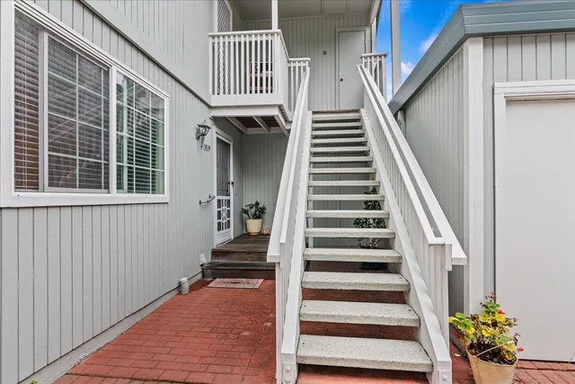 a kitchen with stainless steel appliances white cabinets sink and stove top oven