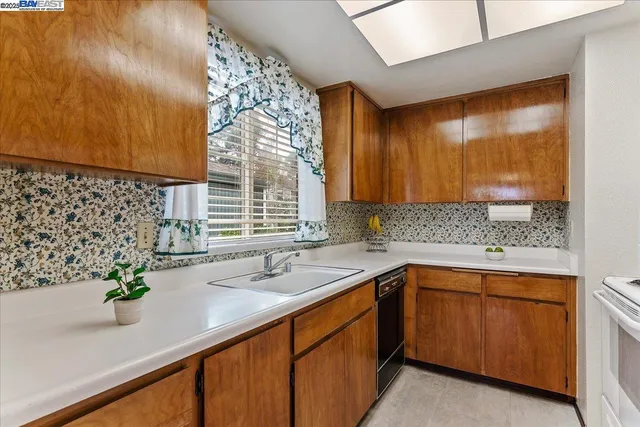 a kitchen with a sink and large window