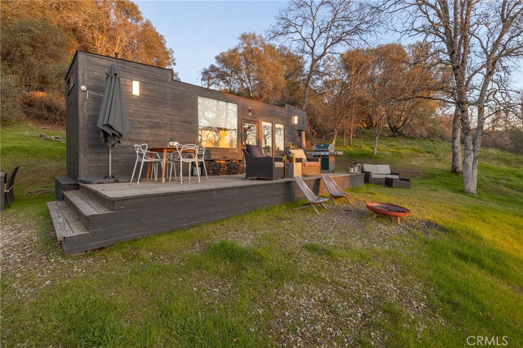 a view of a house with backyard and sitting area