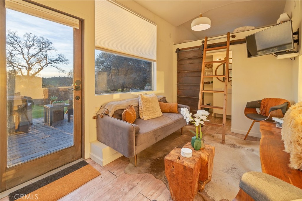 33940 Jennifer Way Coarsegold, CA 93614 - Photo 9 of 75 a living room with furniture and a floor to ceiling window