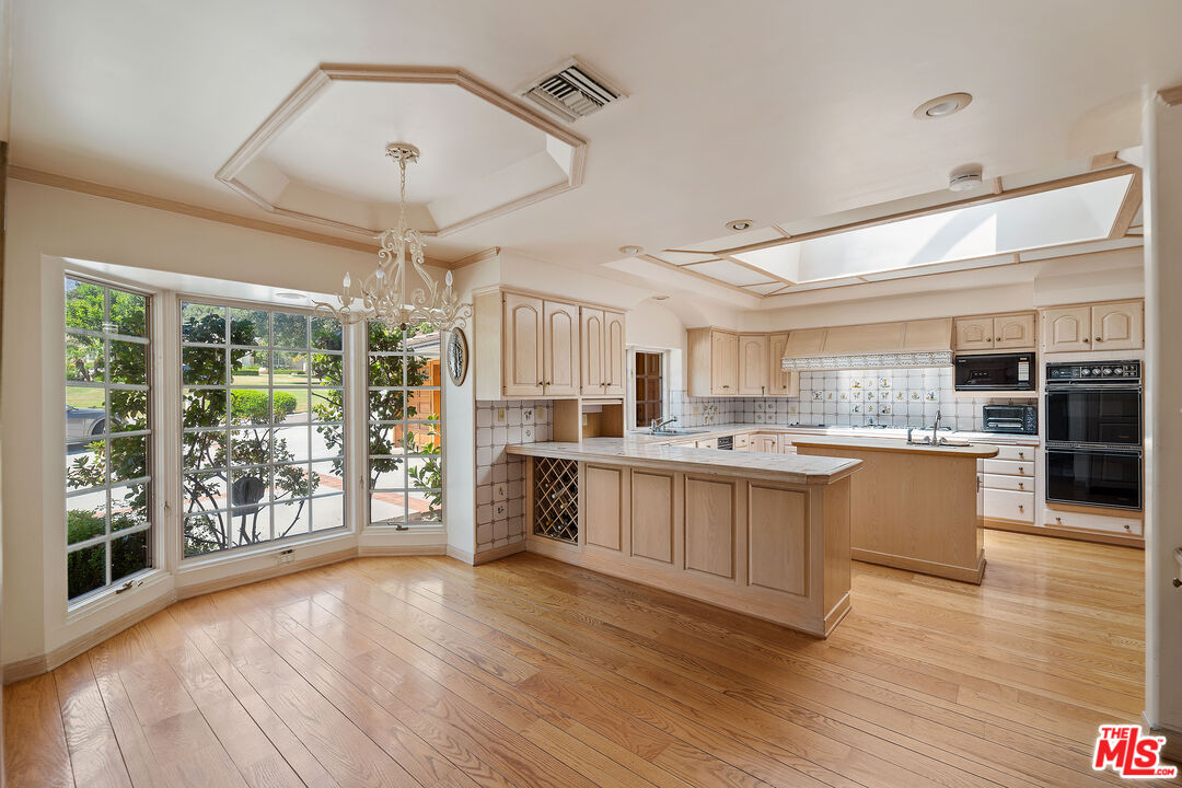 950 Hampton Road Arcadia, CA 91006 - Photo 11 of 33 a large kitchen with a lot of counter space and a wooden floor