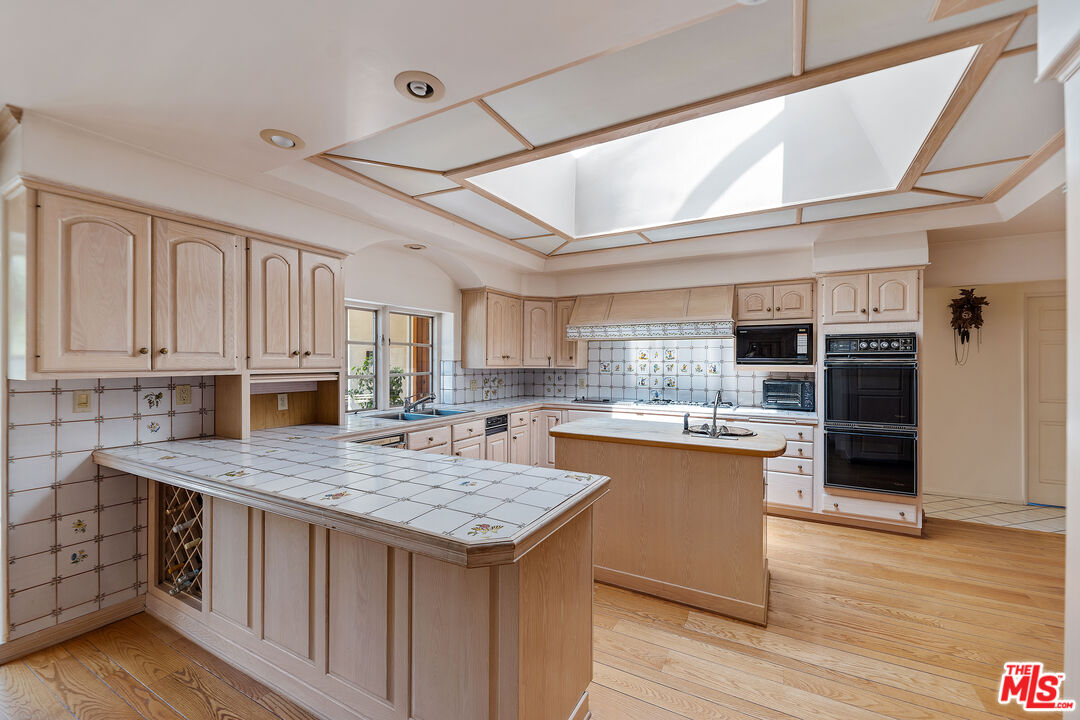 950 Hampton Road Arcadia, CA 91006 - Photo 12 of 33 a kitchen with a stove a refrigerator and wooden floor
