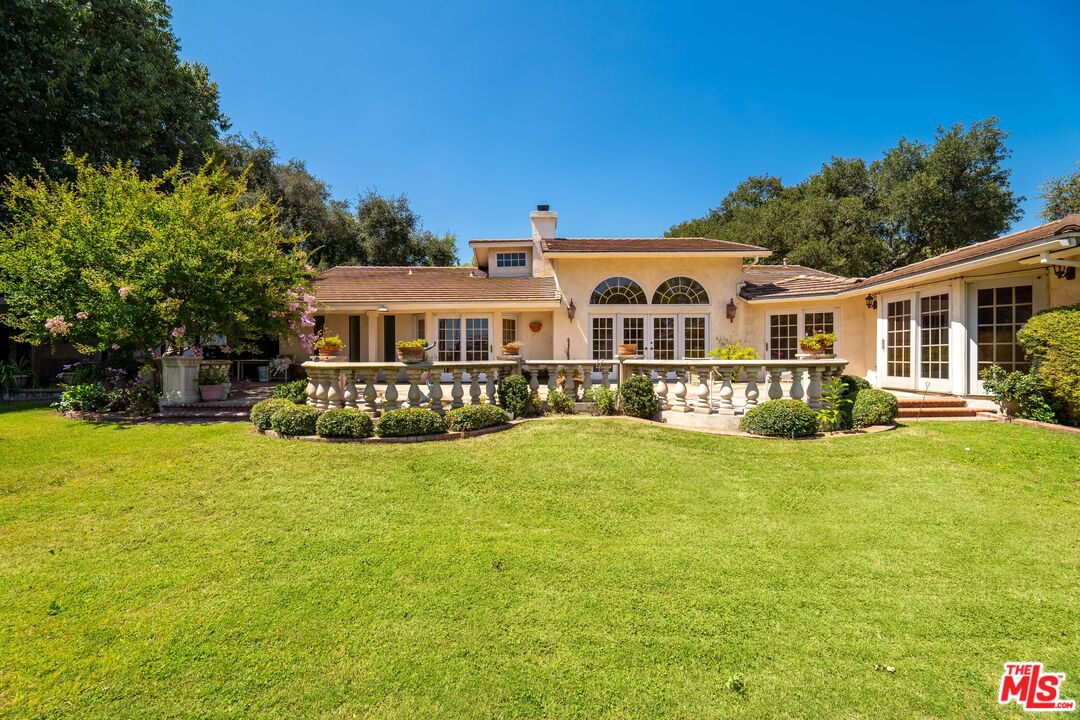 950 Hampton Road Arcadia, CA 91006 - Photo 23 of 33 a front view of a house with a yard table and chairs