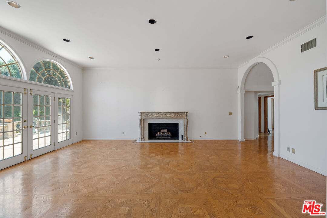 950 Hampton Road Arcadia, CA 91006 - Photo 6 of 33 a view of an empty room with a fireplace and a window