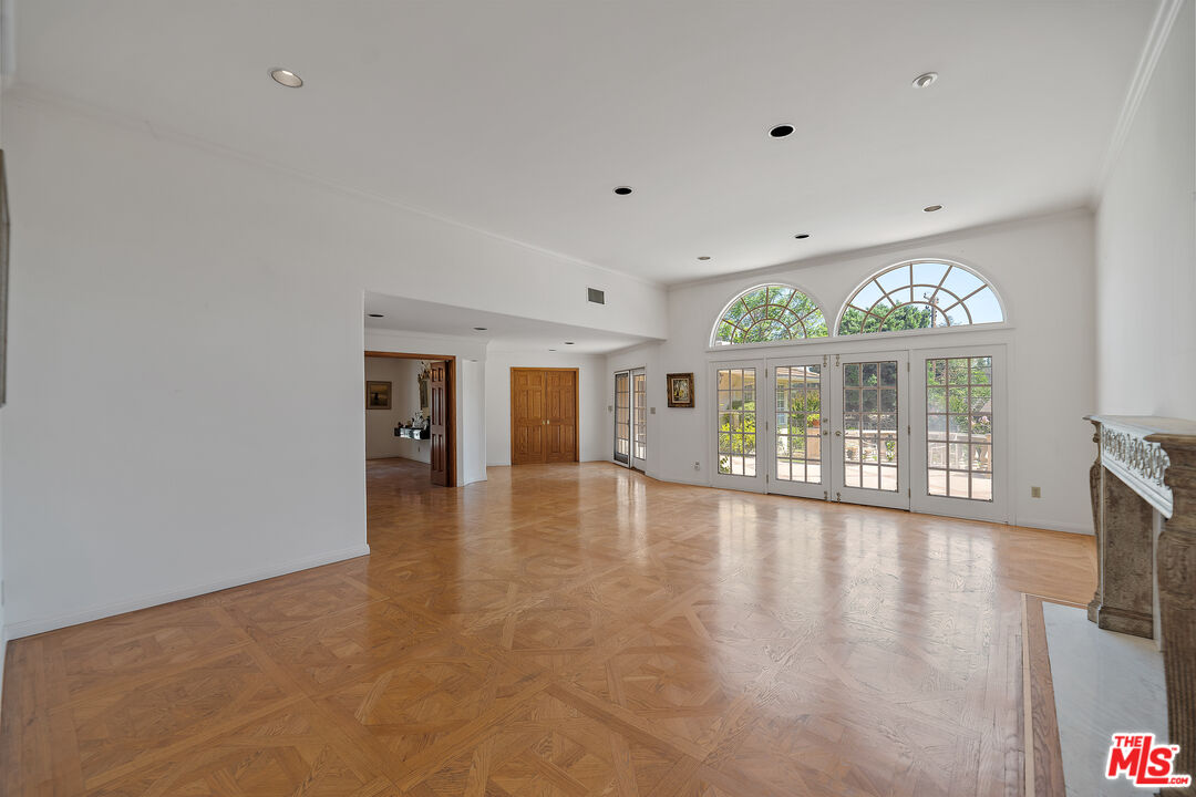 950 Hampton Road Arcadia, CA 91006 - Photo 8 of 33 a view of an empty room with a fireplace and a large window