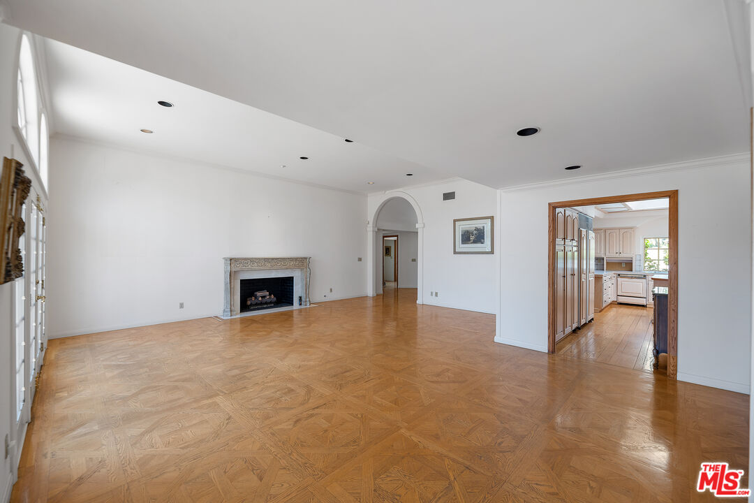 950 Hampton Road Arcadia, CA 91006 - Photo 9 of 33 a view of an empty room with wooden floor and a fireplace