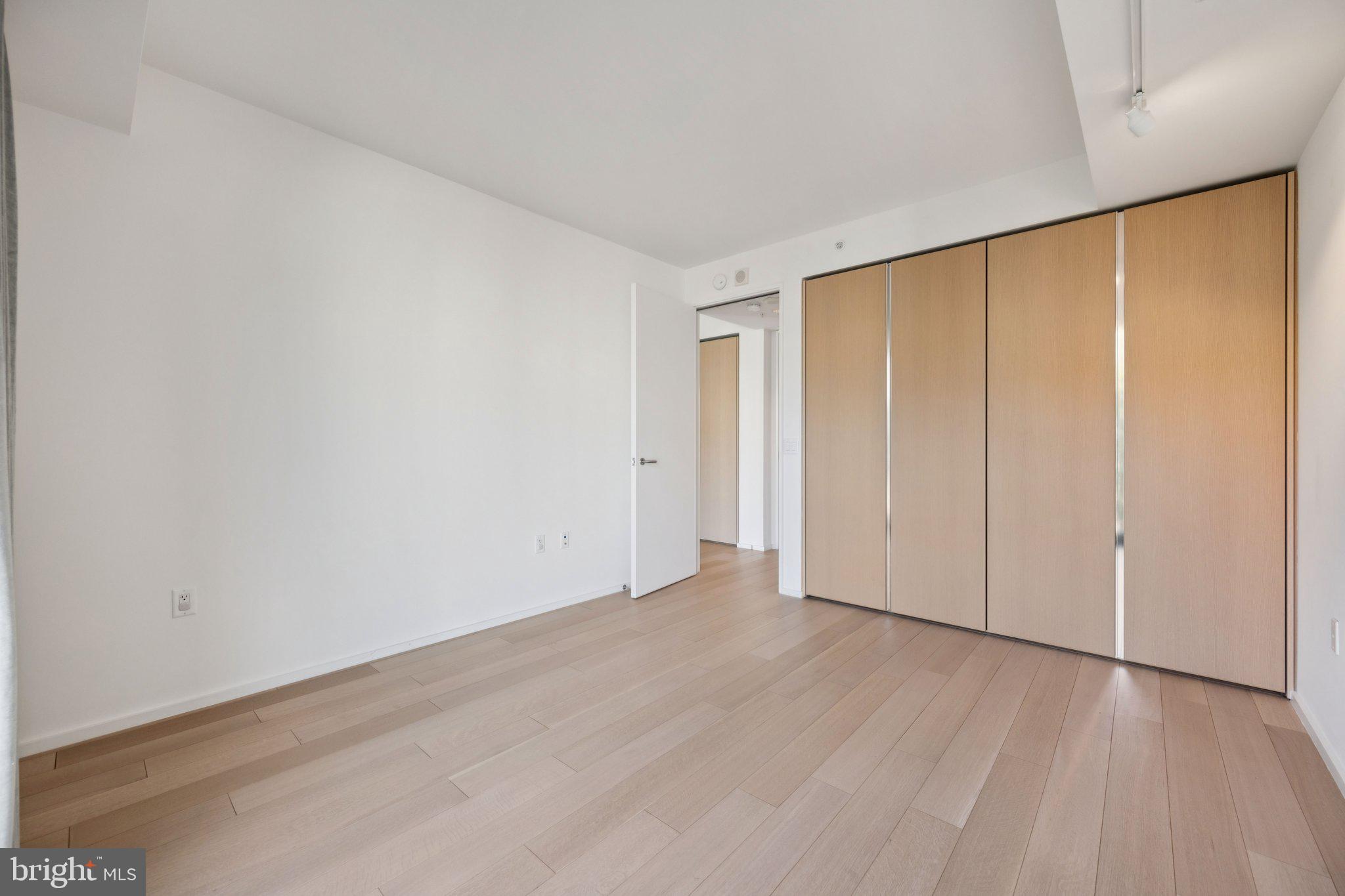 925 H Street Northwest, Unit 903 Washington, DC 20001 - Photo 11 of 36 a view of an empty room with wooden floor