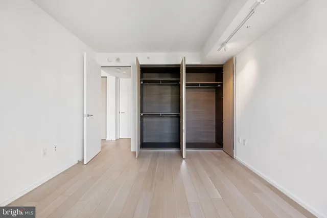 a view of an empty room with closet area