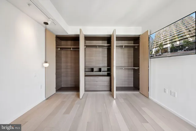 a view of walk in closet with empty racks