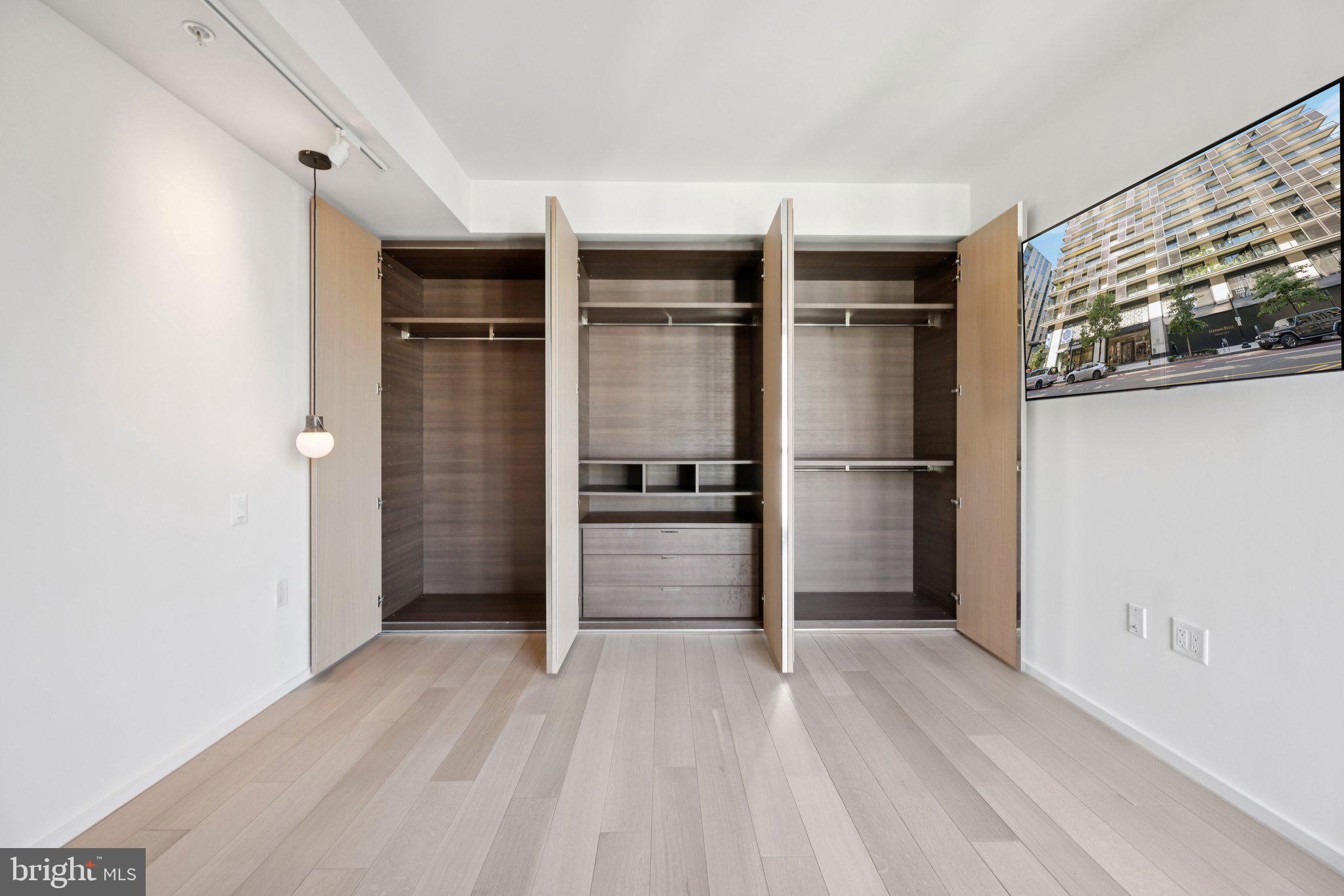 925 H Street Northwest, Unit 903 Washington, DC 20001 - Photo 17 of 36 a view of walk in closet with empty racks