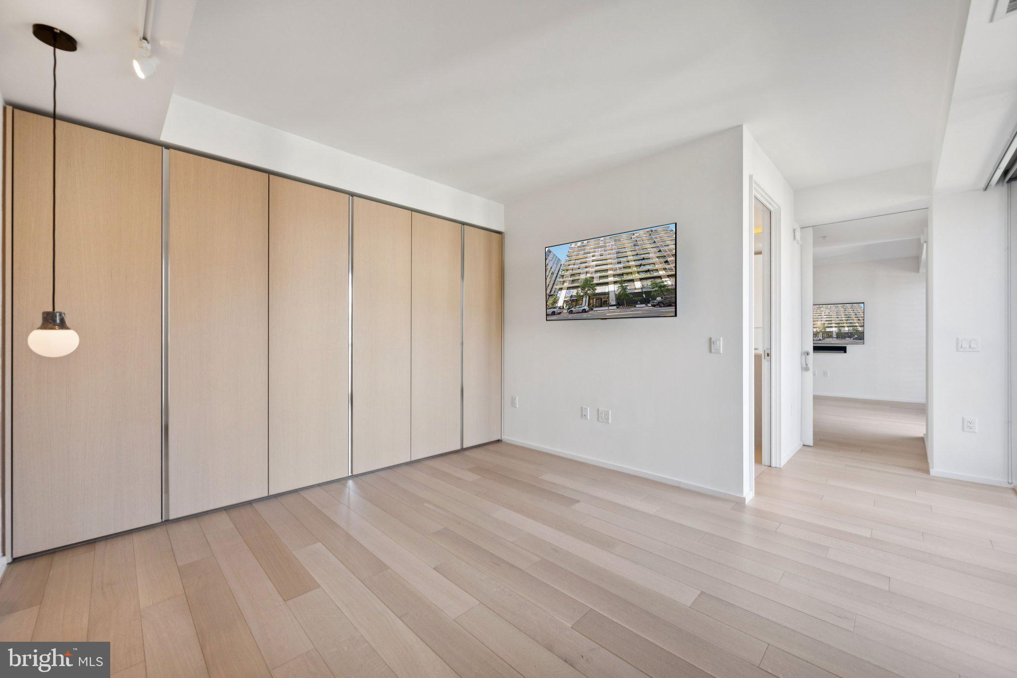 925 H Street Northwest, Unit 903 Washington, DC 20001 - Photo 18 of 36 a view of an empty room with closet and a window