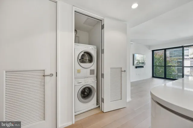 a view of a storage and utility room with washer and dryer
