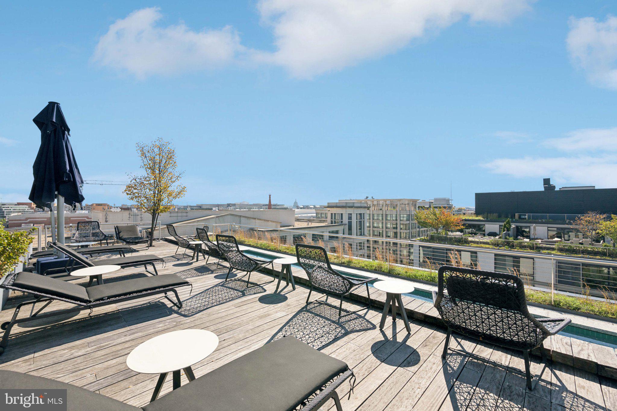 925 H Street Northwest, Unit 903 Washington, DC 20001 - Photo 23 of 36 a living room with furniture and a flat screen tv
