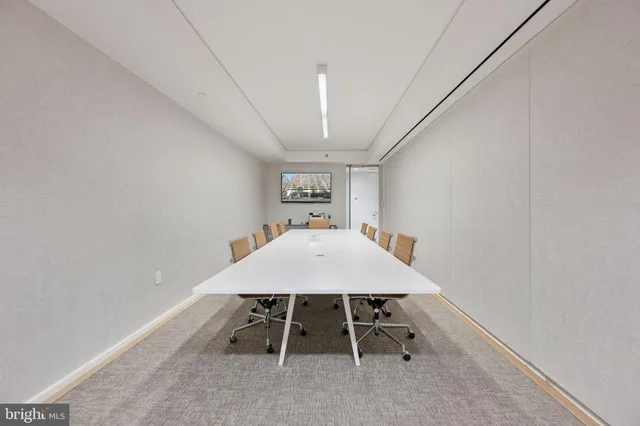 a view of a hallway with a table and chairs