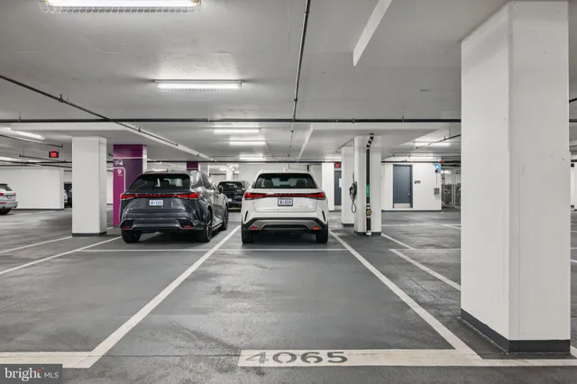a view of parking garage with cars parked