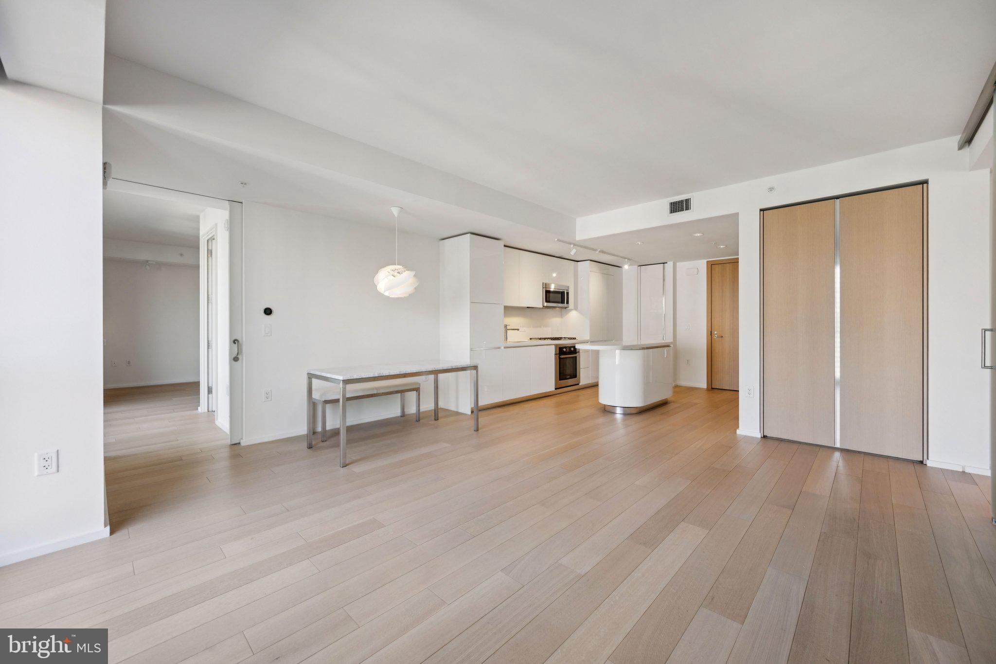 925 H Street Northwest, Unit 903 Washington, DC 20001 - Photo 3 of 36 a view of a kitchen with a sink and a refrigerator