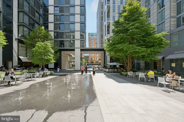 a front view of a residential apartment building with a yard