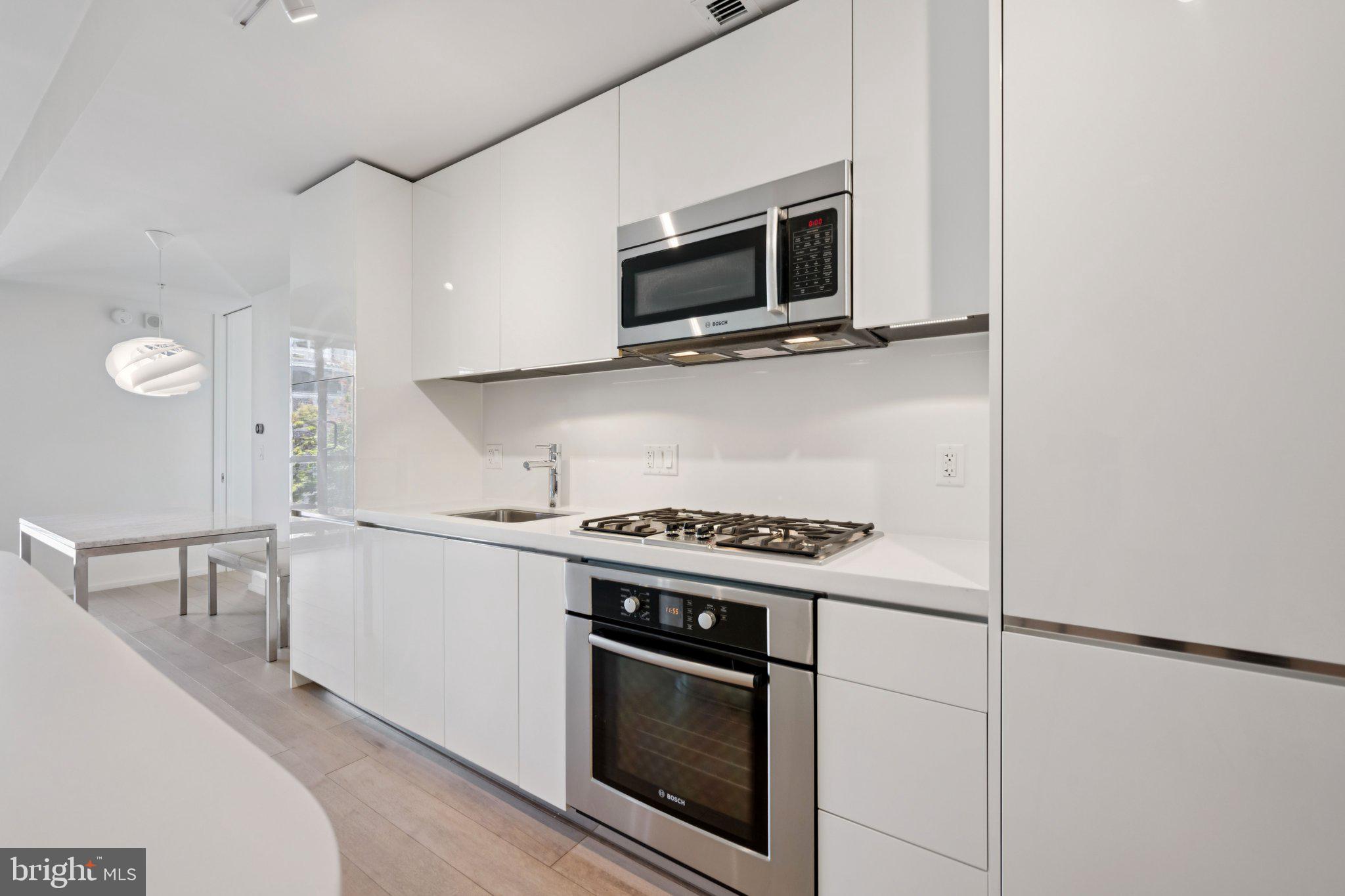 925 H Street Northwest, Unit 903 Washington, DC 20001 - Photo 6 of 36 a kitchen with a stove and a microwave
