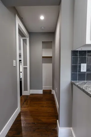 a view of hallway with wooden floor
