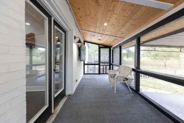 a view of a large room with large windows and a table