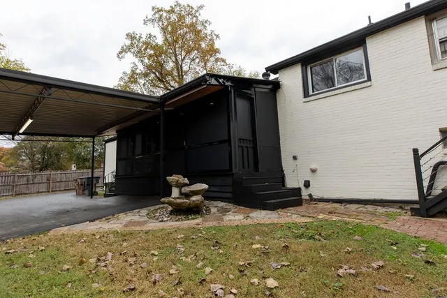 a backyard of a house with table and chairs