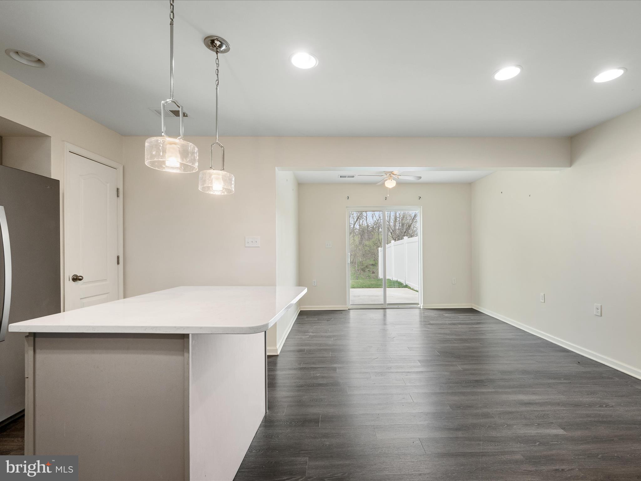 640 Thumper Drive Ranson, WV 25438 - Photo 11 of 50 a view of an empty room with wooden floor and a kitchen