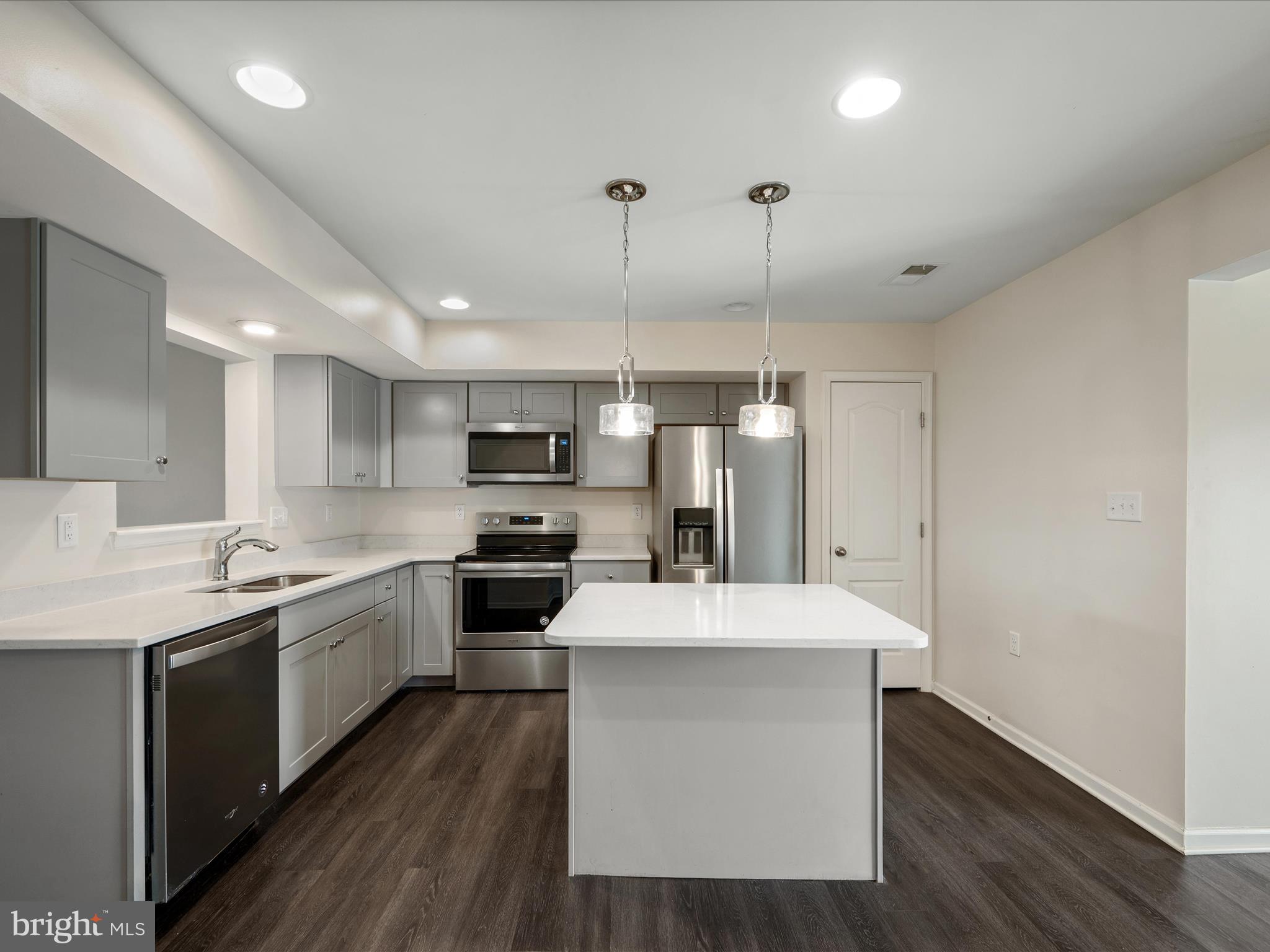 640 Thumper Drive Ranson, WV 25438 - Photo 12 of 50 a kitchen with a sink a counter top space stainless steel appliances and cabinets