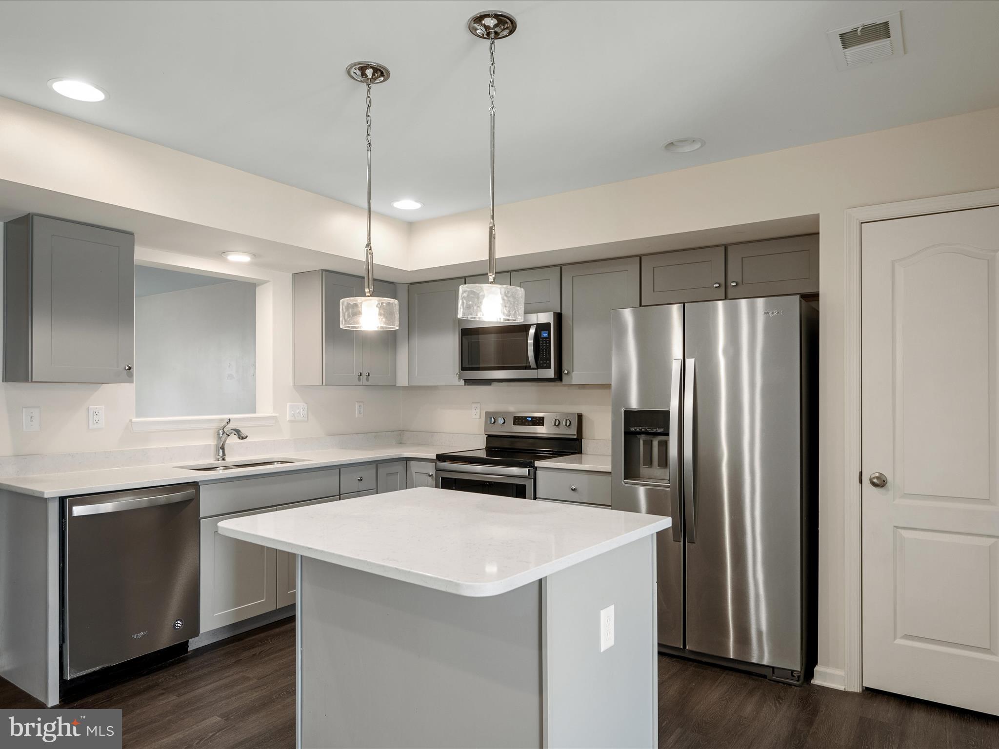 640 Thumper Drive Ranson, WV 25438 - Photo 13 of 50 a kitchen with a sink a counter space appliances and cabinets
