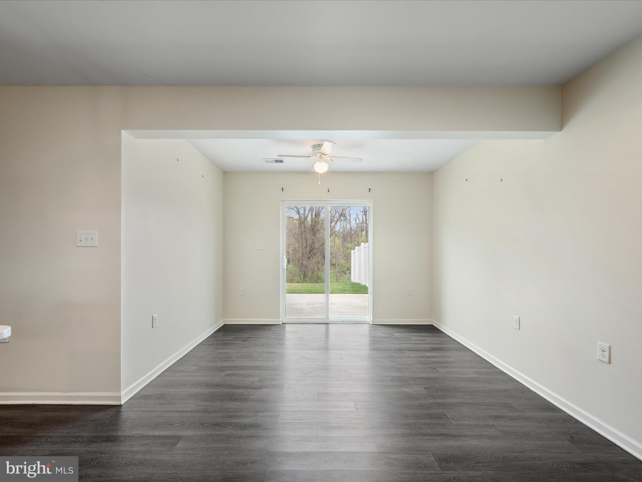 640 Thumper Drive Ranson, WV 25438 - Photo 16 of 50 a view of an empty room with wooden floor and a window