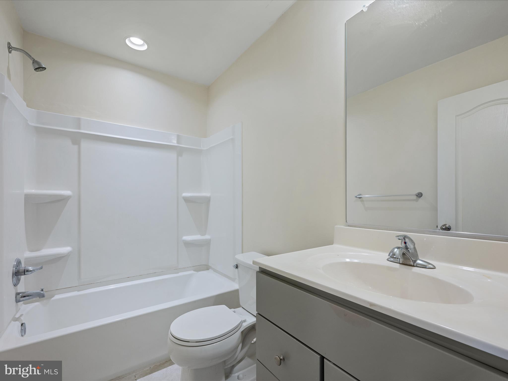 640 Thumper Drive Ranson, WV 25438 - Photo 24 of 50 a bathroom with a granite countertop sink a toilet and shower