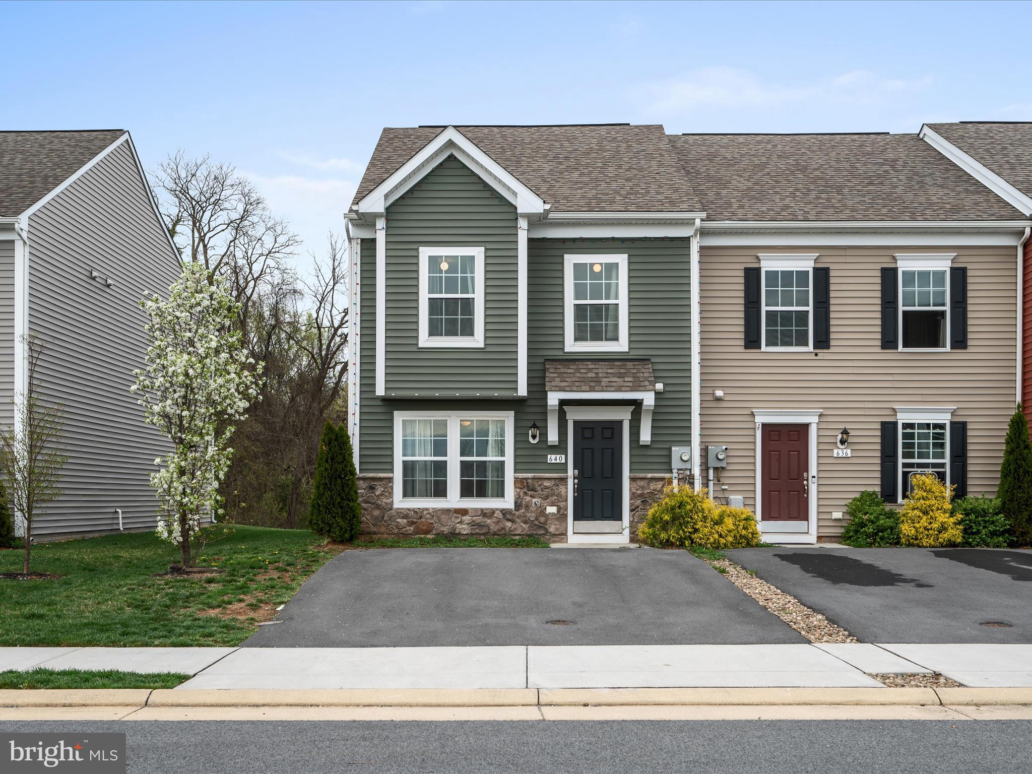 640 Thumper Drive Ranson, WV 25438 - Photo 3 of 50 a view of a brick house with a yard plants and large tree
