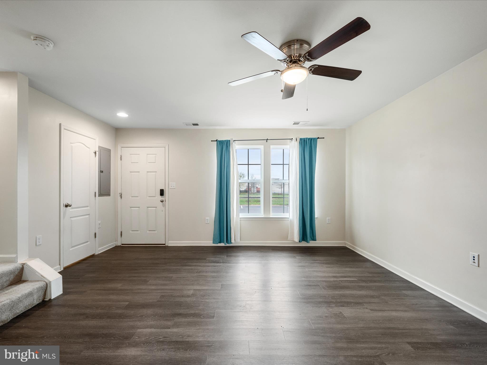 640 Thumper Drive Ranson, WV 25438 - Photo 9 of 50 a view of an empty room with wooden floor and a window
