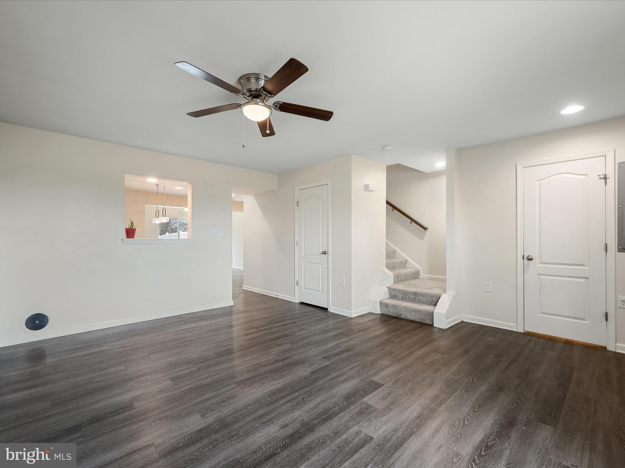 640 Thumper Drive Ranson, WV 25438 - Photo 10 of 50 a view of an empty room with wooden floor and a ceiling fan