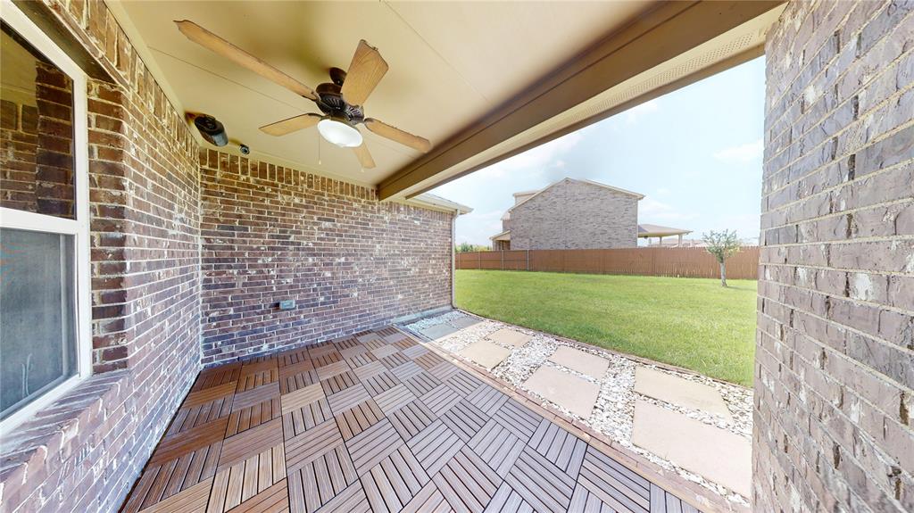 3101 Buckthorn Street Forney, TX 75126 - Photo 10 of 40 Covered patio featuring wood-finish tile flooring and brick exterior walls