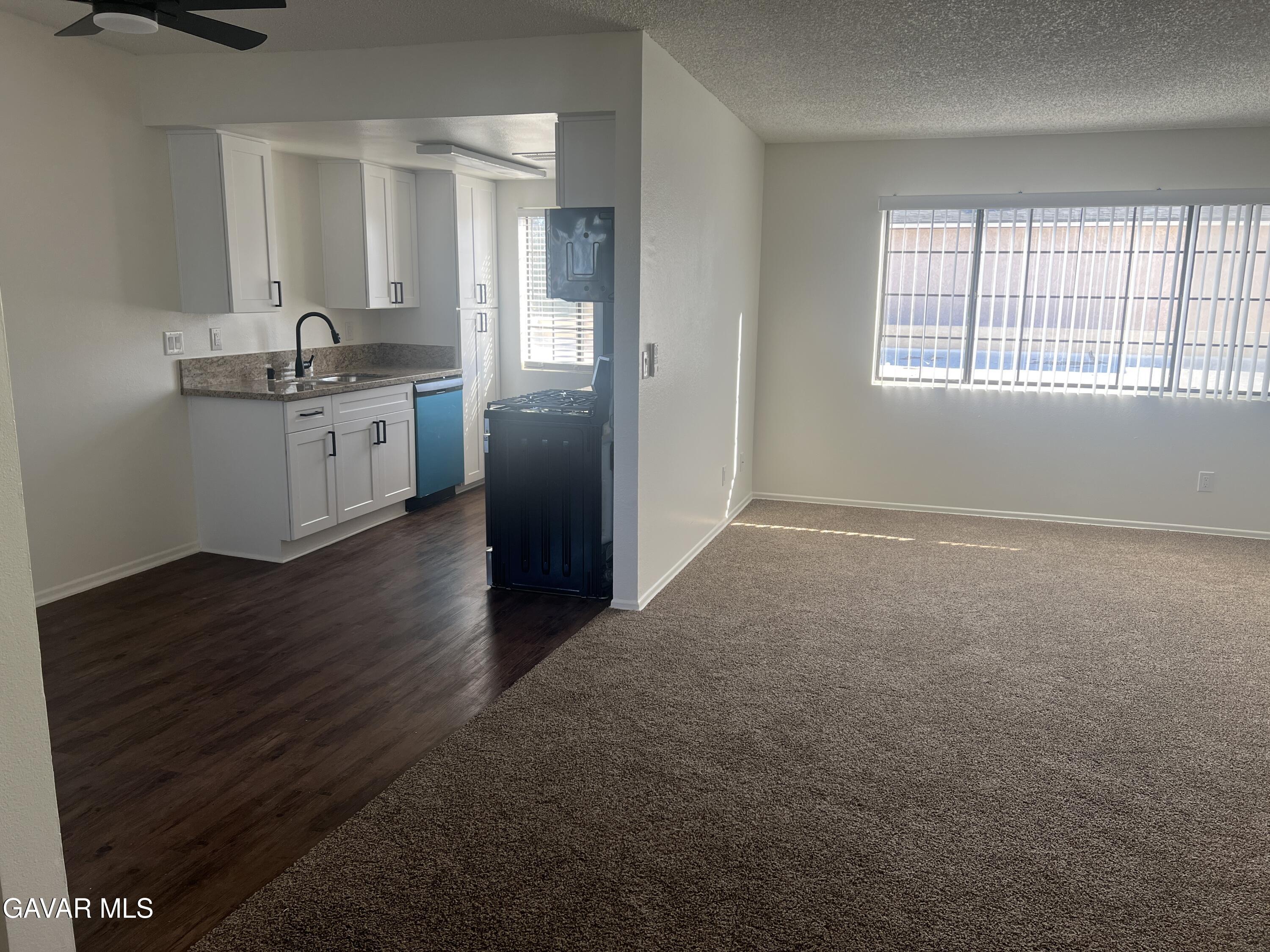 4202 West Ave L, Unit 7 Quartz Hill, CA 93536 - Photo 7 of 14 a kitchen with granite countertop a sink cabinets and a window