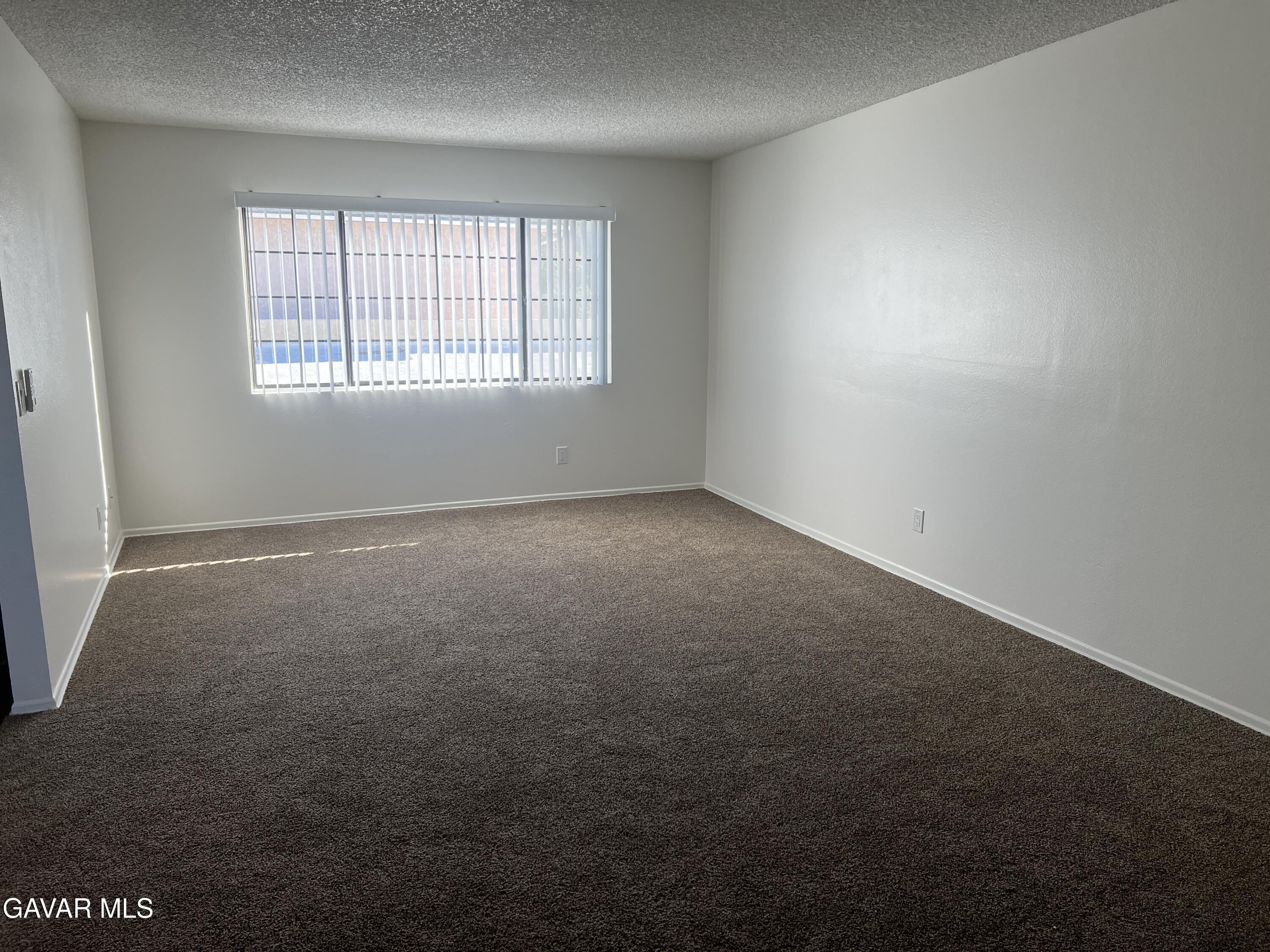 4202 West Ave L, Unit 7 Quartz Hill, CA 93536 - Photo 8 of 14 an empty room with windows