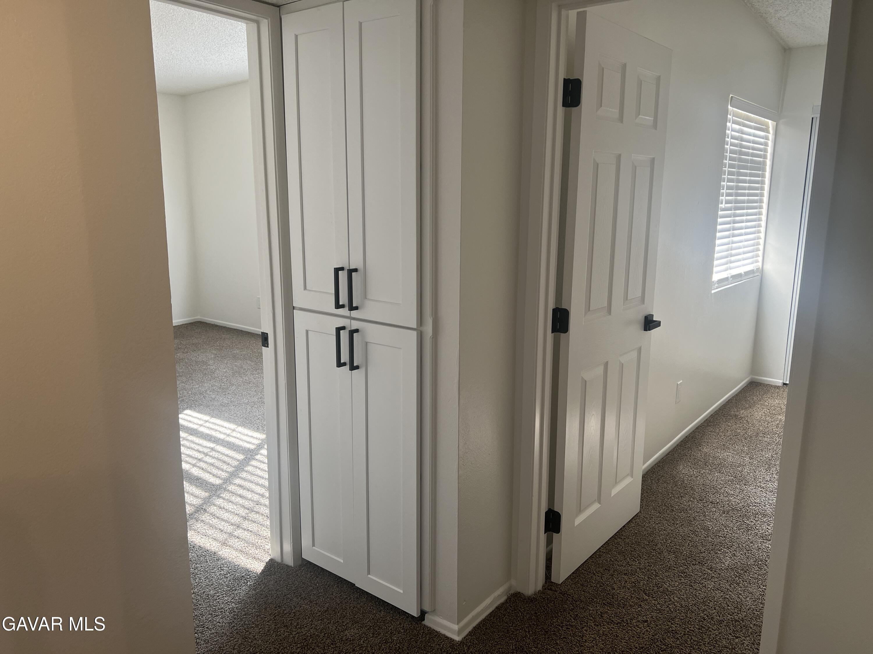 4202 West Ave L, Unit 7 Quartz Hill, CA 93536 - Photo 10 of 14 a view of a hallway with wooden floor and closet