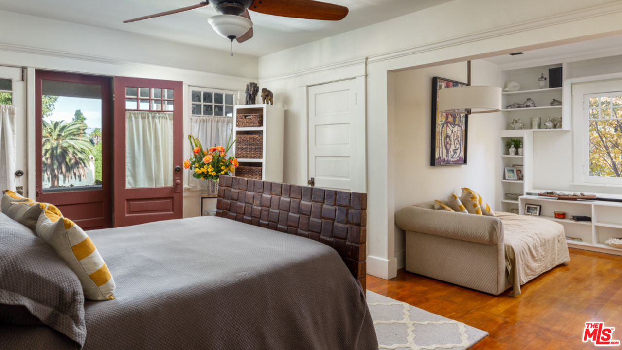 4570 University Avenue Riverside, CA 92501 - Photo 25 of 40 a bedroom with a large bed couch and a window