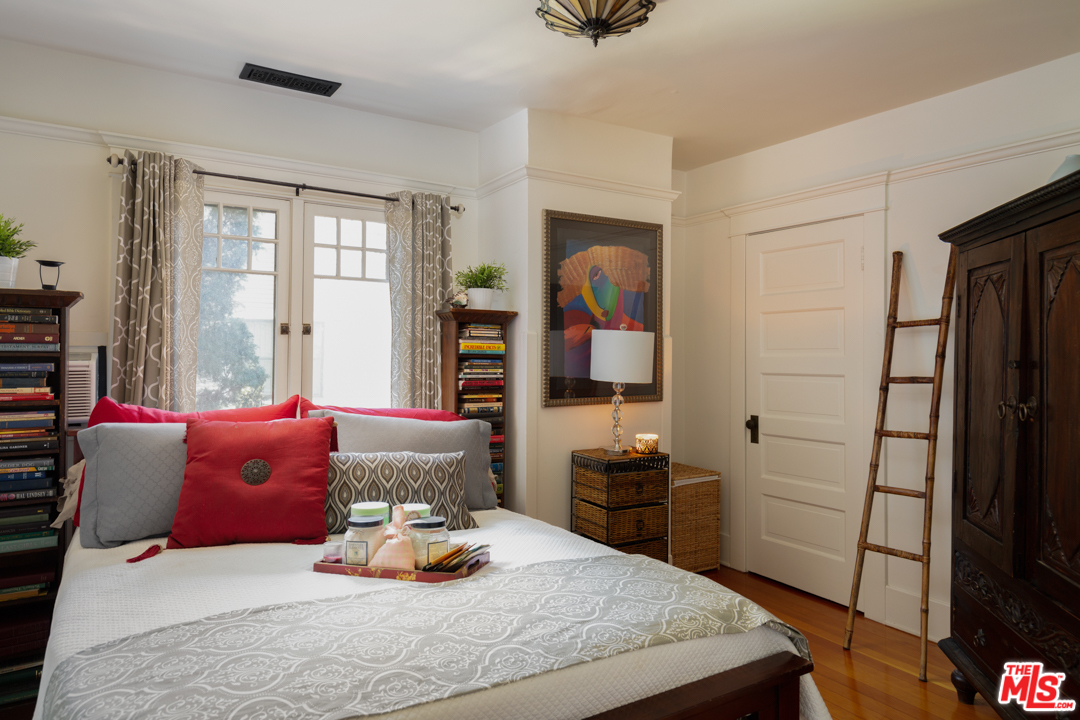 4570 University Avenue Riverside, CA 92501 - Photo 29 of 40 a bedroom with a bed and wooden floor