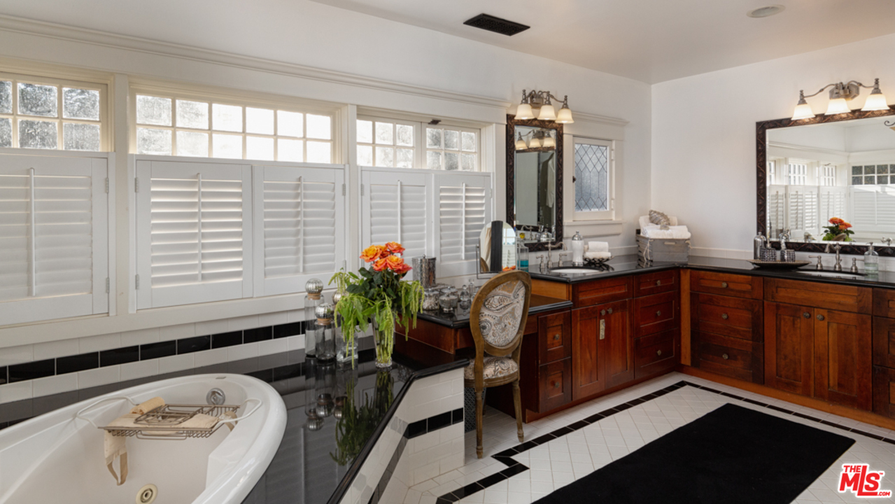 4570 University Avenue Riverside, CA 92501 - Photo 32 of 40 a bathroom with a tub sink and mirror