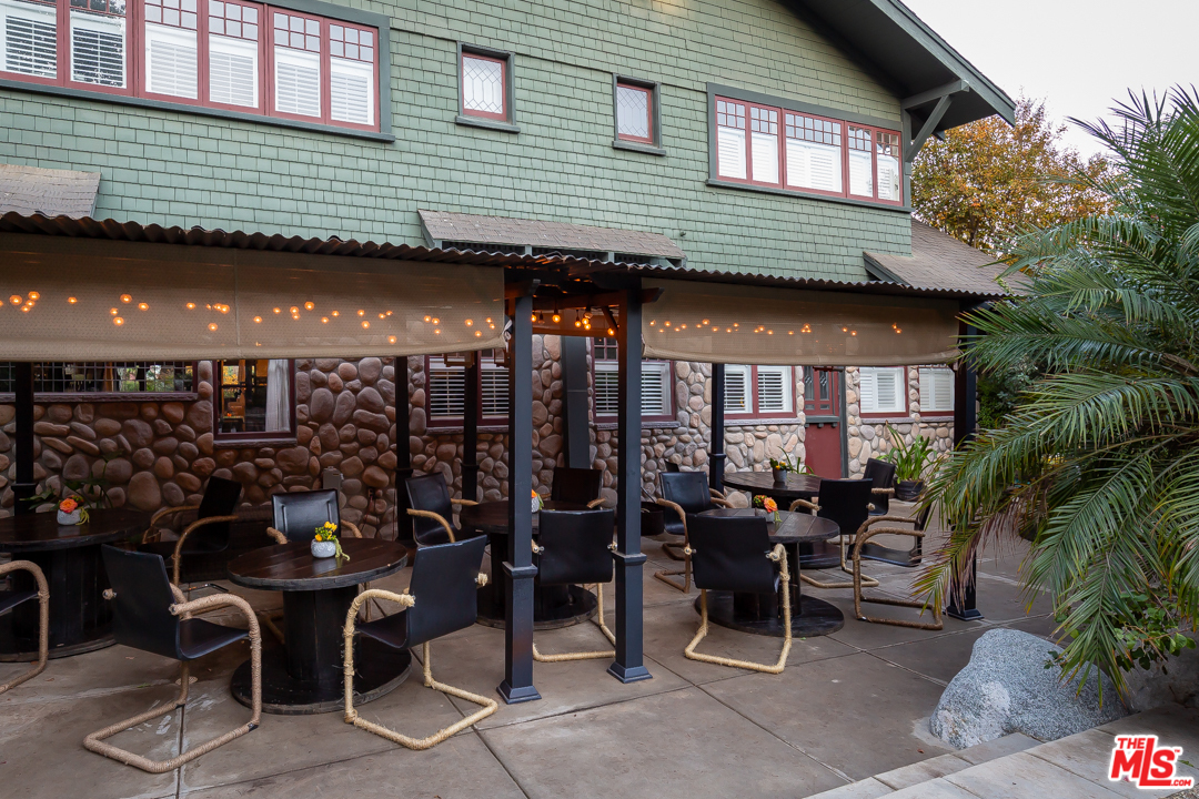 4570 University Avenue Riverside, CA 92501 - Photo 33 of 40 a view of a patio with table and chairs and potted plants
