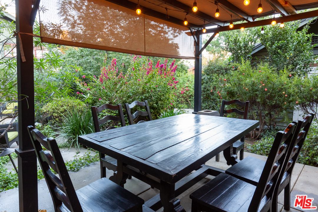 4570 University Avenue Riverside, CA 92501 - Photo 38 of 40 a view of a patio with table and chairs and wooden floor