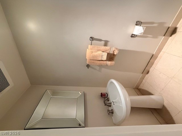 2777 Paradise Road, Unit 807 Las Vegas, NV 89109 - Photo 30 of 61 A well-appointed lavatory with a pristine pedestal sink and wall-mounted towel holders.