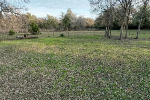 a view of outdoor space with green field and trees
