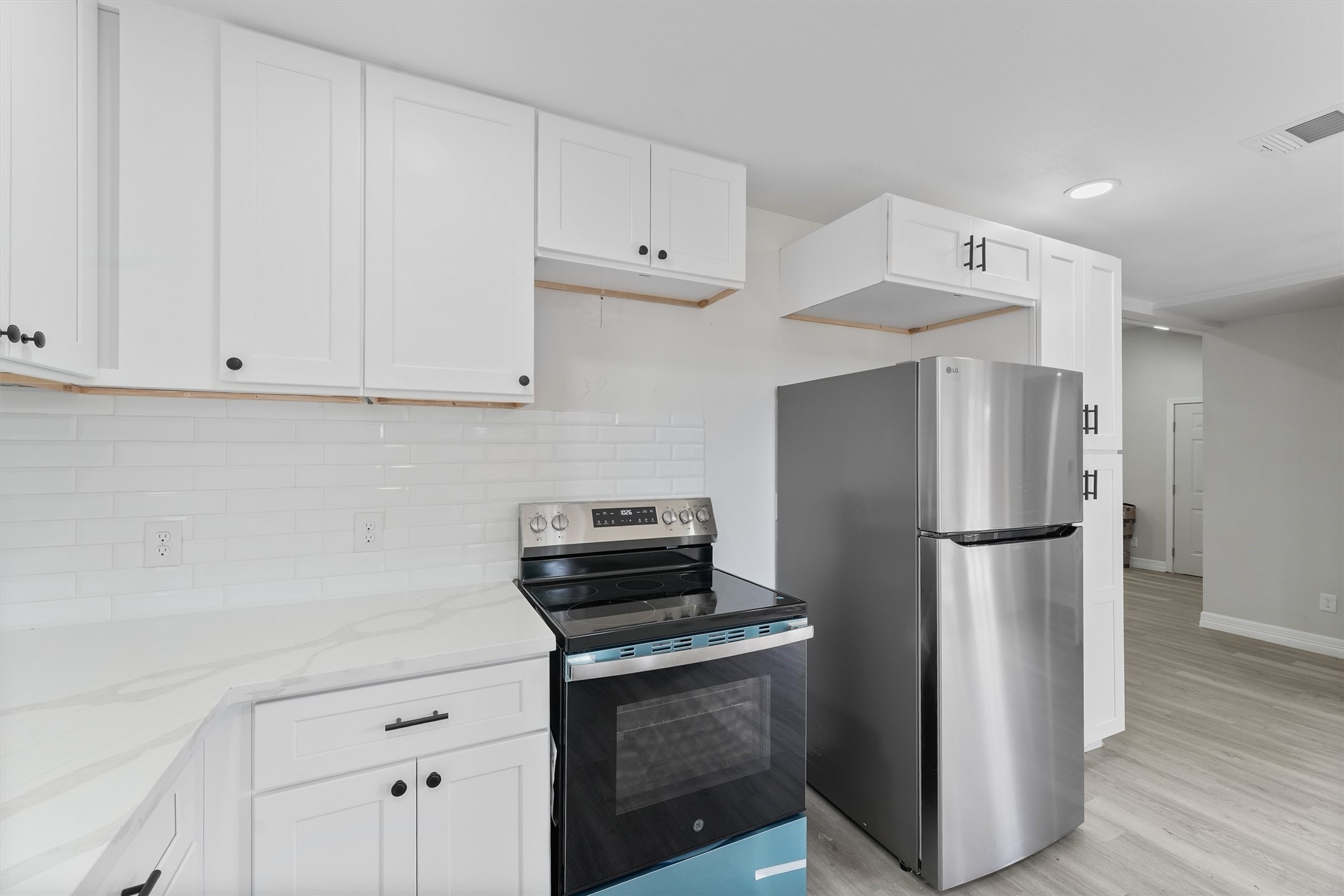 1615 Hiller Street Houston, TX 77015 - Photo 14 of 26 a kitchen with refrigerator and cabinets