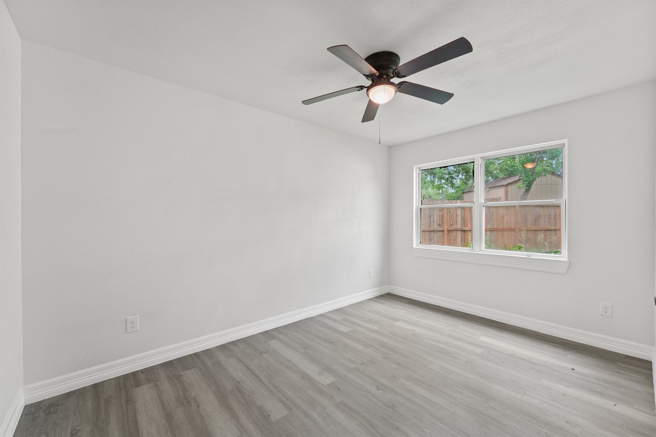 1615 Hiller Street Houston, TX 77015 - Photo 20 of 26 a view of a big room with wooden floor and windows