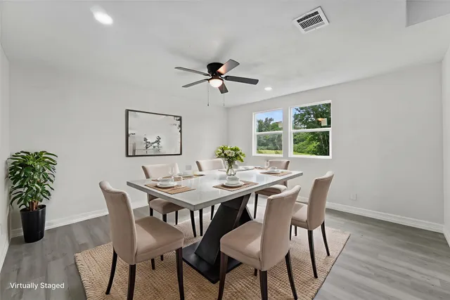 a view of a dining room with furniture window and wooden floor