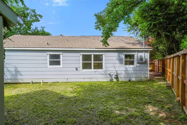 a house with a tree in the grass