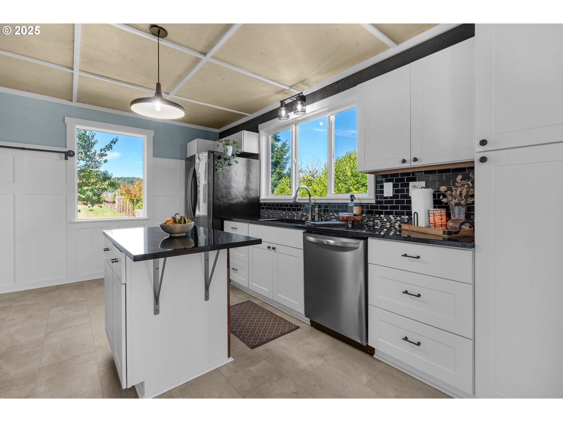 90635 Spring Road Astoria, OR 97103 - Photo 19 of 38 a kitchen with stainless steel appliances kitchen island granite countertop a sink a counter space and cabinets