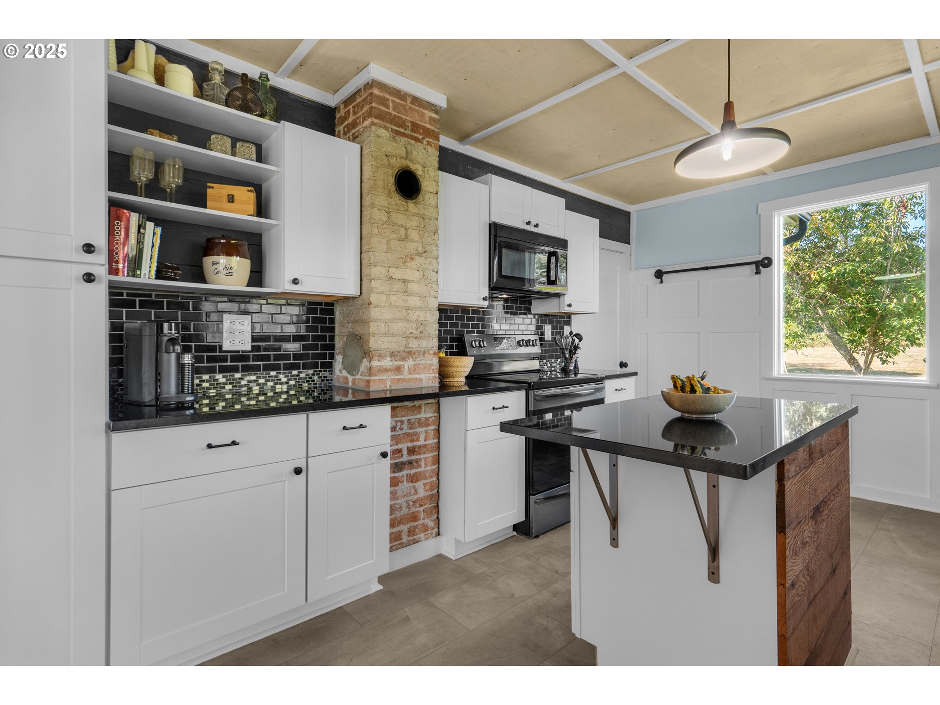 90635 Spring Road Astoria, OR 97103 - Photo 20 of 38 a kitchen with stainless steel appliances kitchen island granite countertop a sink and cabinets
